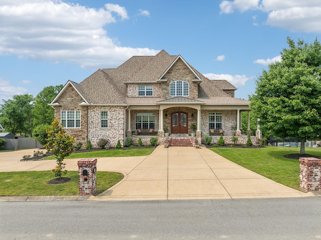 226 Hidden Harbour Dr, Mount Juliet, TN 37122 - craftsman house with a front lawn, french doors, a shingled roof, covered porch, and stone siding