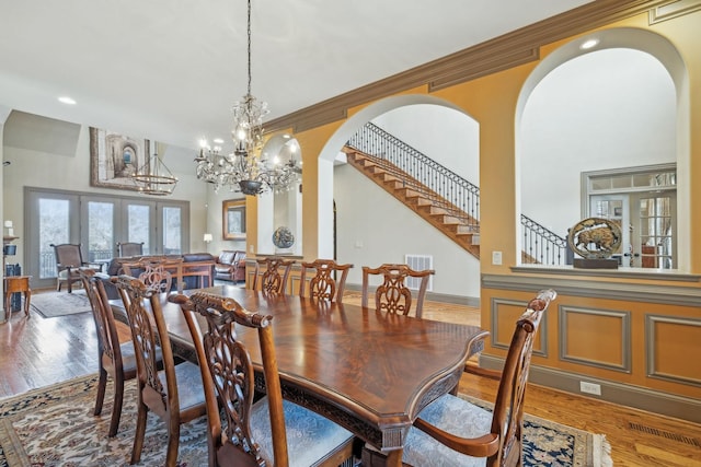 226 Hidden Harbour Dr, Mount Juliet, TN 37122 - dining room featuring arched walkways, wood finished floors, stairway, a chandelier, and recessed lighting