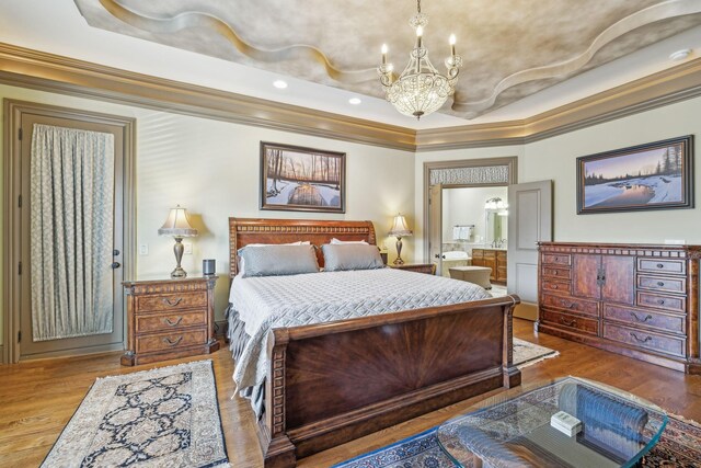 226 Hidden Harbour Dr, Mount Juliet, TN 37122 - bedroom with a chandelier, crown molding, a raised ceiling, wood finished floors, and connected bathroom