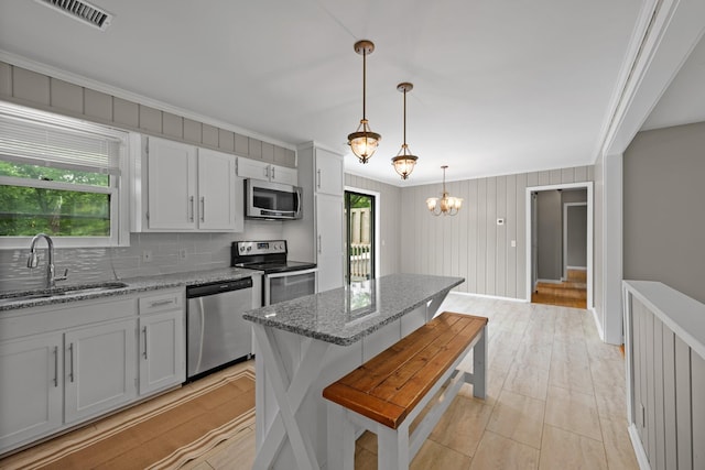 109 Hazelwood Dr, Hendersonville, TN 37075 - kitchen with stainless steel appliances, a sink, crown molding, tasteful backsplash, and light stone counters
