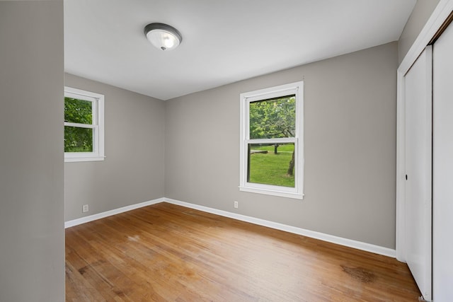 109 Hazelwood Dr, Hendersonville, TN 37075 - unfurnished bedroom with multiple windows, baseboards, light wood-style floors, and a closet