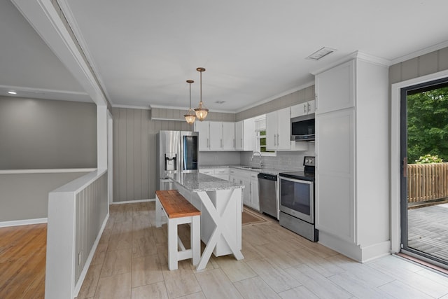 109 Hazelwood Dr, Hendersonville, TN 37075 - kitchen with stainless steel appliances, a sink, light stone countertops, a kitchen bar, and white cabinetry