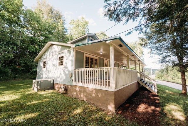 1799 Baker Hwy, Huntsville, TN 37756 - view of home's exterior with central AC unit, covered porch, and a yard