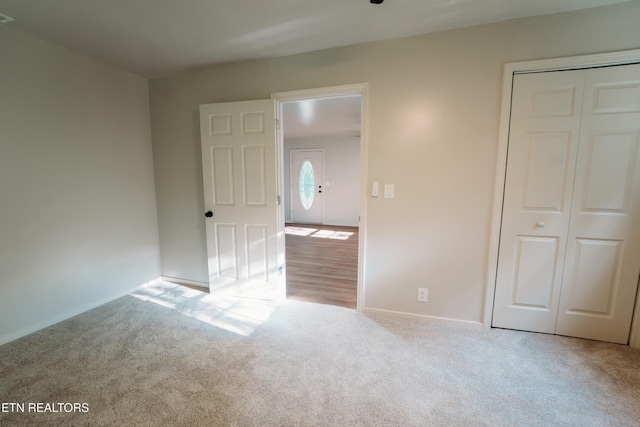 1799 Baker Hwy, Huntsville, TN 37756 - unfurnished bedroom featuring carpet floors, a closet, and baseboards