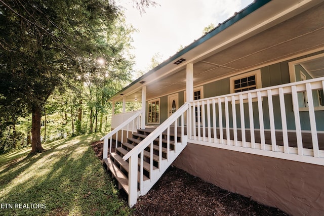 1799 Baker Hwy, Huntsville, TN 37756 - view of exterior entry with covered porch and a yard