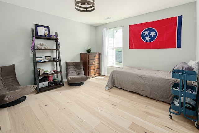 7546 Delancey Dr, College Grove, TN 37046 - bedroom featuring wood finished floors and a chandelier