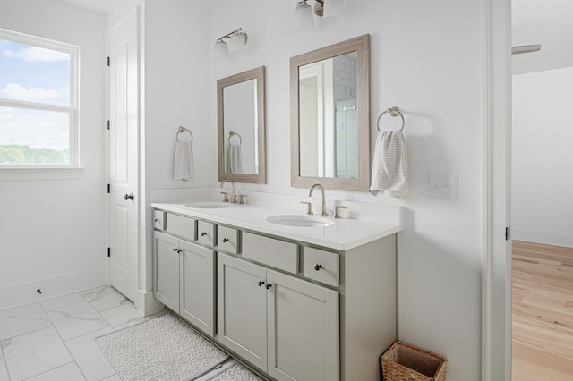 7546 Delancey Dr, College Grove, TN 37046 - bathroom featuring double vanity, baseboards, and marble look tile flooring