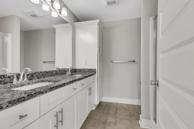 1081 Wells Way, Spring Hill, TN 37174 - full bathroom featuring double vanity, tile patterned flooring, baseboards, and a shower with shower door