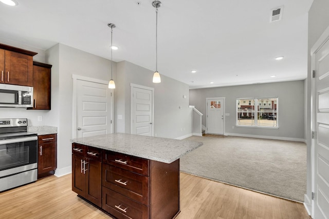 1081 Wells Way, Spring Hill, TN 37174 - kitchen with stainless steel appliances, light wood finished floors, pendant lighting, a kitchen island, and light stone counters