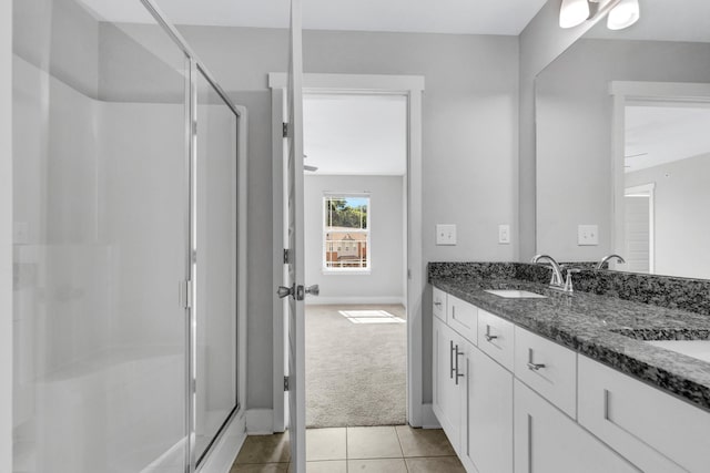 1081 Wells Way, Spring Hill, TN 37174 - bathroom featuring a stall shower, double vanity, tile patterned floors, and baseboards