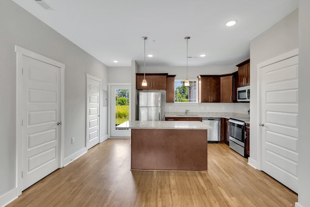 1081 Wells Way, Spring Hill, TN 37174 - kitchen featuring stainless steel appliances, a kitchen island, light wood-style flooring, and recessed lighting