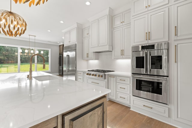724 Bradshaw Rd, Lebanon, TN 37087 - kitchen featuring appliances with stainless steel finishes, a sink, a chandelier, decorative light fixtures, and white cabinets