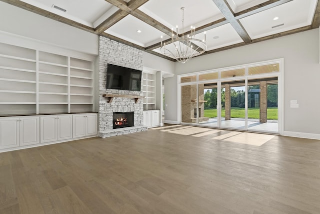 724 Bradshaw Rd, Lebanon, TN 37087 - unfurnished living room with baseboards, coffered ceiling, a chandelier, a stone fireplace, and wood finished floors