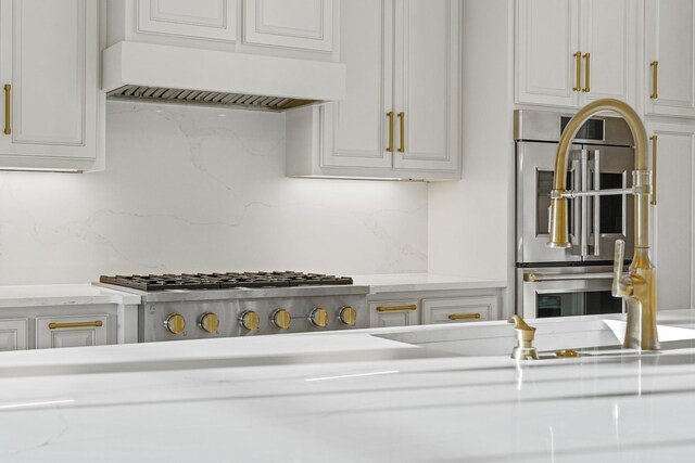 724 Bradshaw Rd, Lebanon, TN 37087 - kitchen with premium range hood, backsplash, white cabinets, and light stone counters