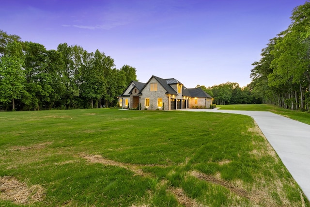 724 Bradshaw Rd, Lebanon, TN 37087 - view of front of home featuring stone siding, concrete driveway, a front yard, and a garage