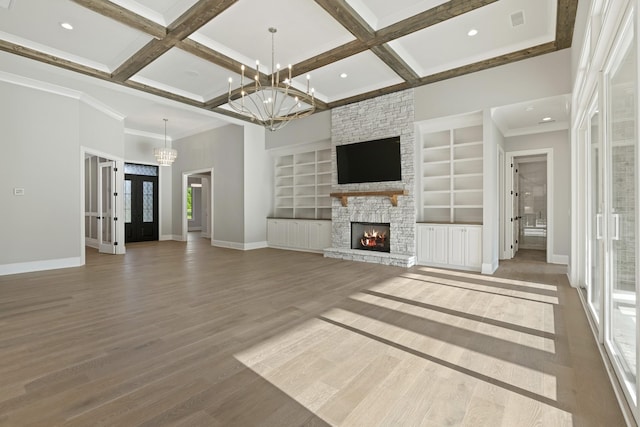 724 Bradshaw Rd, Lebanon, TN 37087 - unfurnished living room with a chandelier, baseboards, a stone fireplace, coffered ceiling, and wood finished floors