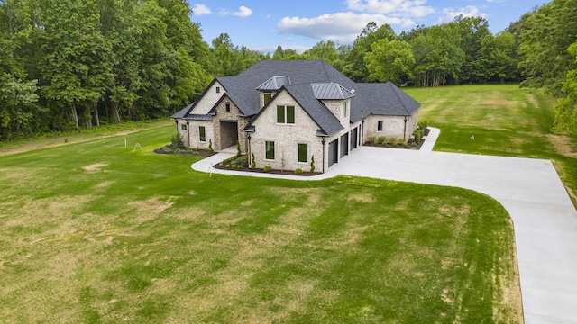 724 Bradshaw Rd, Lebanon, TN 37087 - french country home with stone siding, driveway, a front lawn, and a standing seam roof