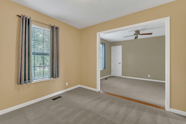 4132 Philhall Pkwy, Antioch, TN 37013 - spare room featuring carpet flooring, baseboards, ceiling fan, and a textured ceiling