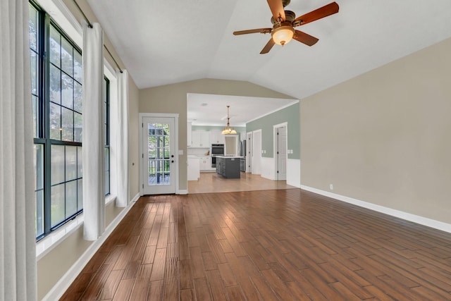 4132 Philhall Pkwy, Antioch, TN 37013 - unfurnished living room with dark wood-style flooring, ceiling fan, baseboards, and lofted ceiling