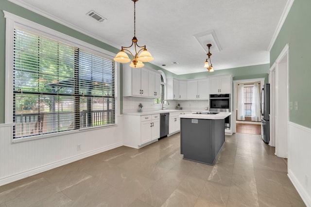 4132 Philhall Pkwy, Antioch, TN 37013 - kitchen with appliances with stainless steel finishes, light countertops, a sink, a center island, and crown molding