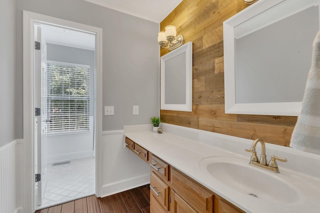 4132 Philhall Pkwy, Antioch, TN 37013 - bathroom with wooden walls, vanity, ornamental molding, wood finished floors, and baseboards