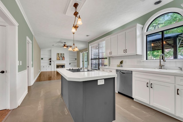 4132 Philhall Pkwy, Antioch, TN 37013 - kitchen featuring stainless steel dishwasher, a sink, a ceiling fan, black electric stovetop, and a fireplace
