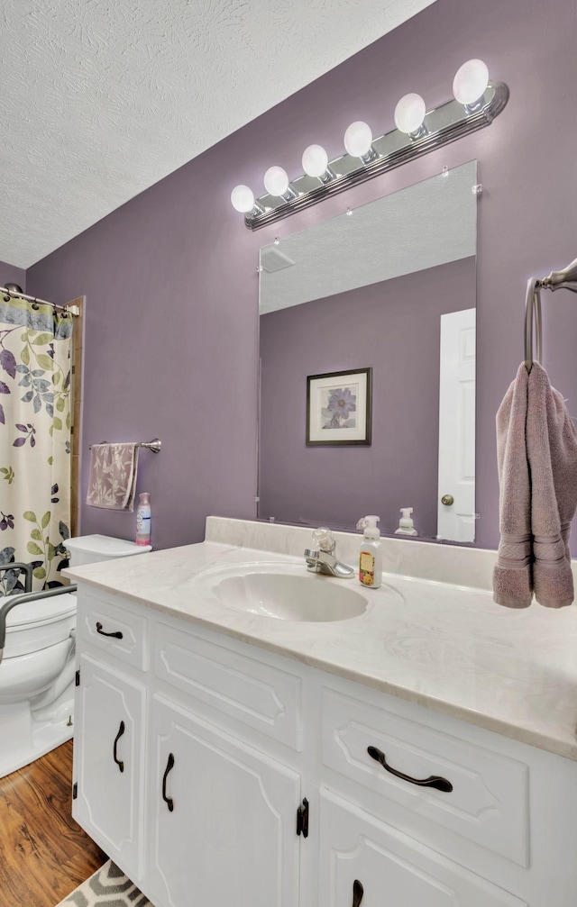 1545 Carthage Hwy, Lebanon, TN 37087 - full bathroom featuring toilet, vanity, a textured ceiling, wood finished floors, and a shower with curtain