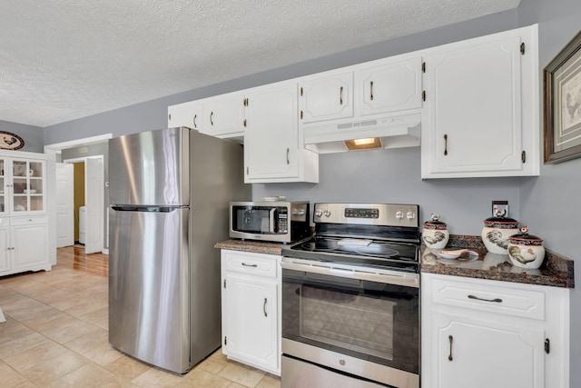 1545 Carthage Hwy, Lebanon, TN 37087 - kitchen with stainless steel appliances, under cabinet range hood, white cabinetry, a textured ceiling, and light tile patterned floors