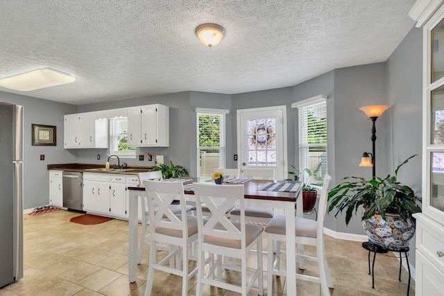 1545 Carthage Hwy, Lebanon, TN 37087 - kitchen with appliances with stainless steel finishes, white cabinets, dark countertops, a sink, and baseboards