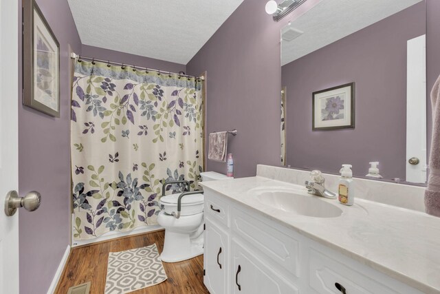 1545 Carthage Hwy, Lebanon, TN 37087 - full bath featuring vanity, toilet, wood finished floors, a textured ceiling, and baseboards