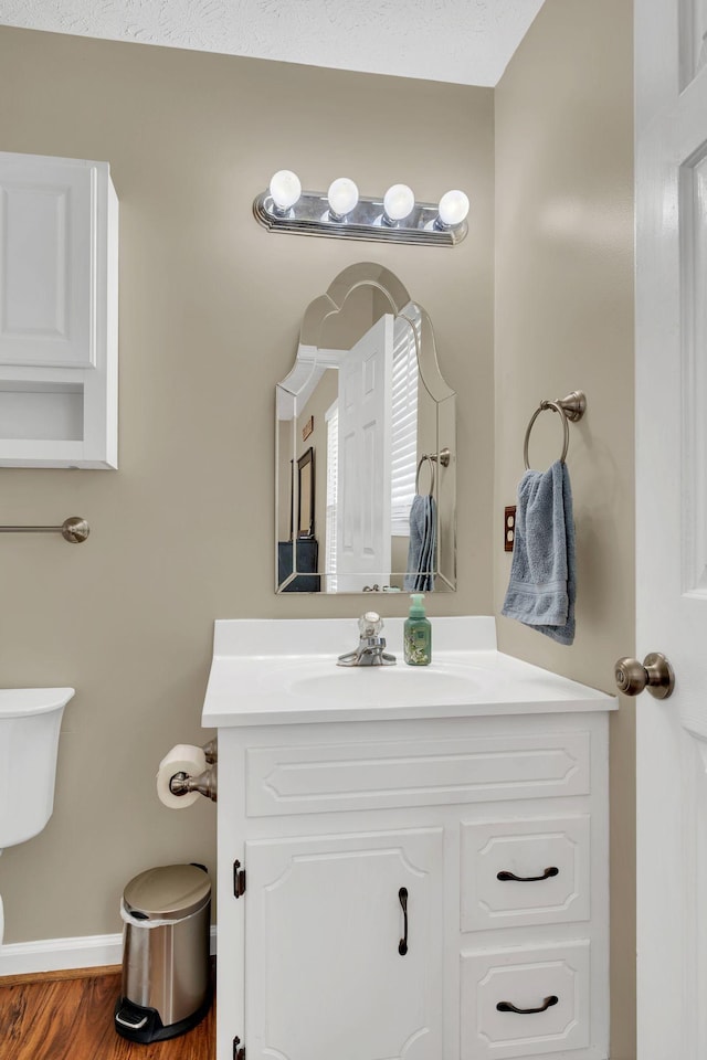 1545 Carthage Hwy, Lebanon, TN 37087 - bathroom with vanity, toilet, baseboards, and wood finished floors