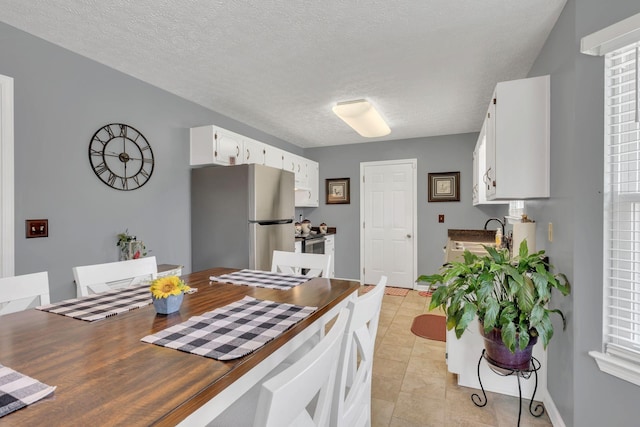 1545 Carthage Hwy, Lebanon, TN 37087 - kitchen with freestanding refrigerator, white cabinets, light tile patterned floors, baseboards, and a textured ceiling