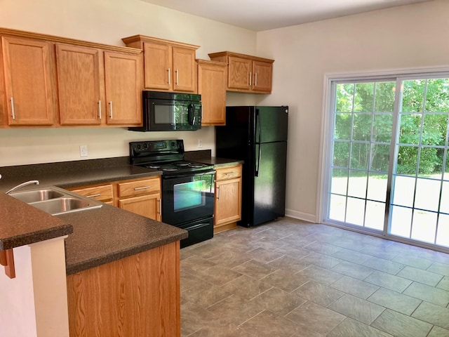 507 Whirlaway Ct, Burns, TN 37029 - kitchen featuring black appliances, dark countertops, and a peninsula