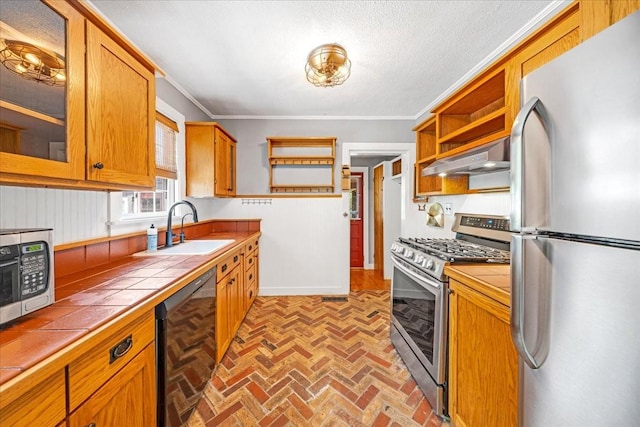 256 Tanksley Ave, Nashville, TN 37211 - kitchen with stainless steel appliances, tile countertops, open shelves, a sink, and brick flooring