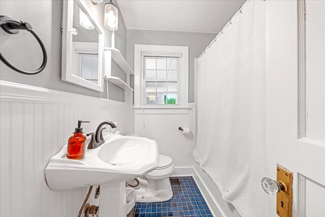 256 Tanksley Ave, Nashville, TN 37211 - bathroom with toilet, tile patterned floors, and a wainscoted wall