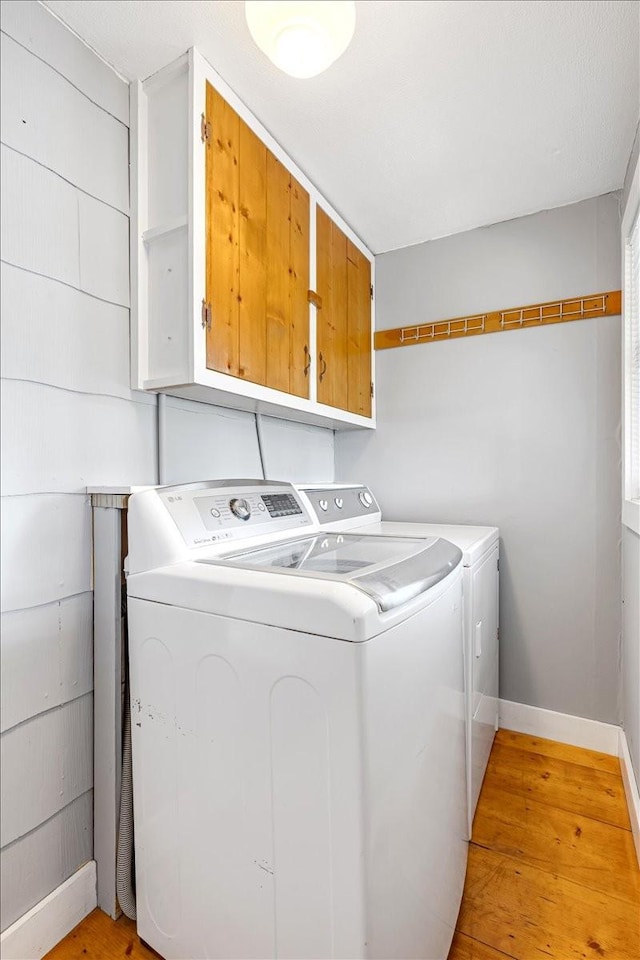 256 Tanksley Ave, Nashville, TN 37211 - washroom featuring separate washer and dryer, cabinet space, light wood finished floors, and baseboards