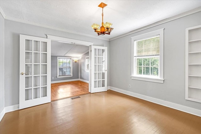 256 Tanksley Ave, Nashville, TN 37211 - unfurnished room with french doors, ornamental molding, wood finished floors, a chandelier, and built in features