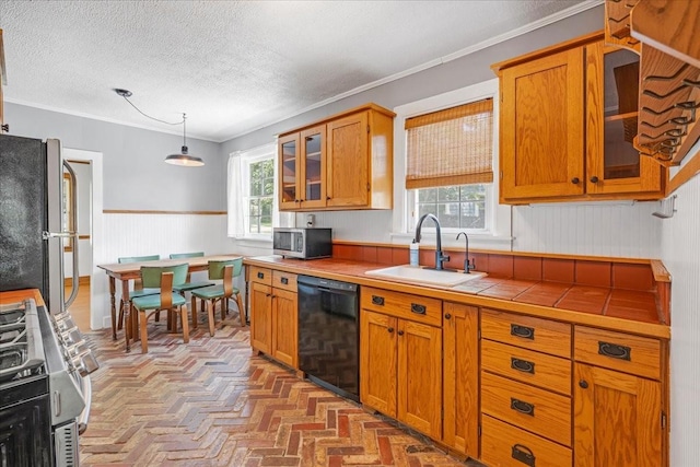 256 Tanksley Ave, Nashville, TN 37211 - kitchen with stainless steel appliances, a sink, brown cabinetry, glass insert cabinets, and ornamental molding