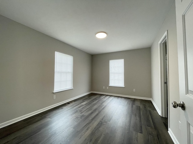 1004 E Railroad St, Waverly, TN 37185 - empty room featuring dark wood-style floors and baseboards