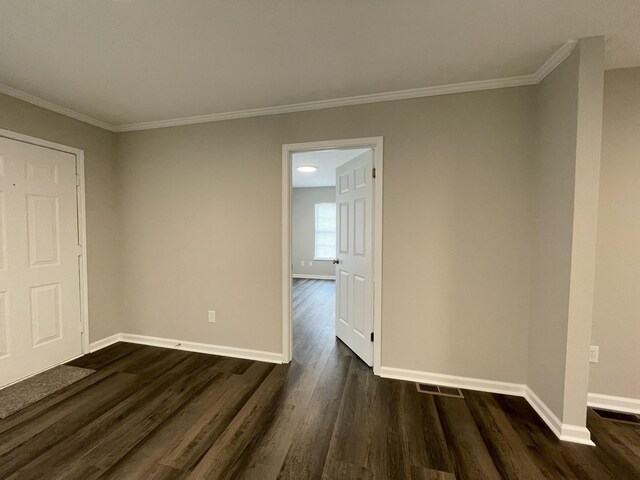 1004 E Railroad St, Waverly, TN 37185 - unfurnished room with baseboards, dark wood-style floors, and crown molding