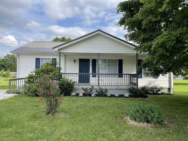 1004 E Railroad St, Waverly, TN 37185 - view of front facade featuring covered porch, a front lawn, and metal roof