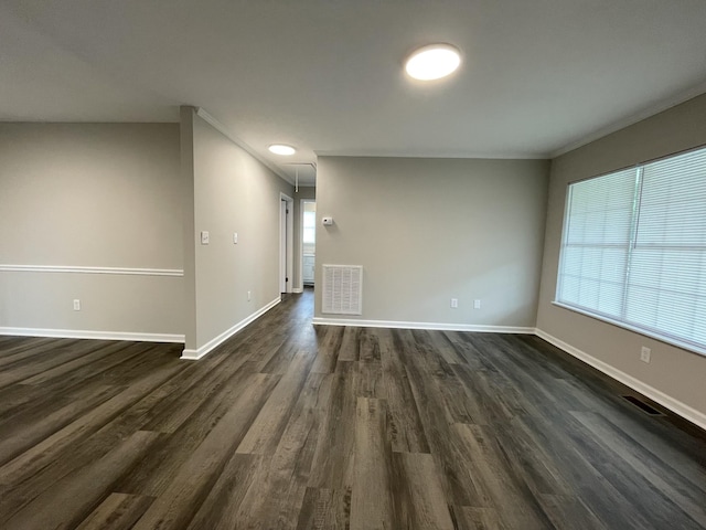 1004 E Railroad St, Waverly, TN 37185 - spare room featuring dark wood-style flooring, attic access, baseboards, and crown molding