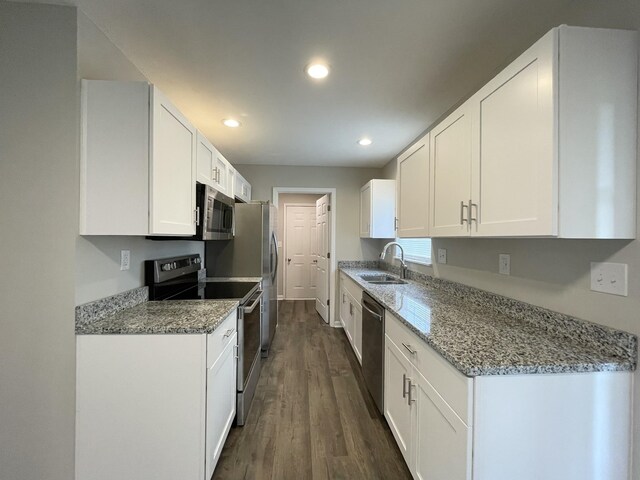 1004 E Railroad St, Waverly, TN 37185 - kitchen featuring stainless steel appliances, a sink, dark wood-style flooring, white cabinets, and recessed lighting