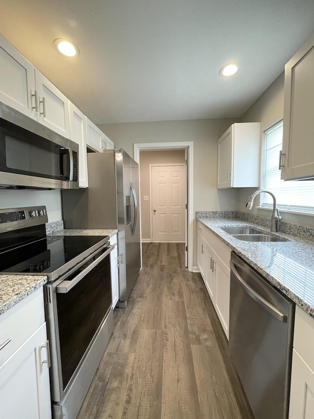 1004 E Railroad St, Waverly, TN 37185 - kitchen with appliances with stainless steel finishes, a sink, dark wood-style flooring, white cabinets, and recessed lighting