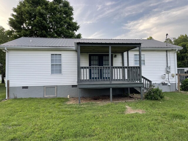 1004 E Railroad St, Waverly, TN 37185 - back of house with a lawn, metal roof, and covered porch