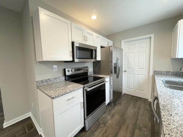 1004 E Railroad St, Waverly, TN 37185 - kitchen featuring appliances with stainless steel finishes, dark wood-style flooring, recessed lighting, white cabinetry, and a sink