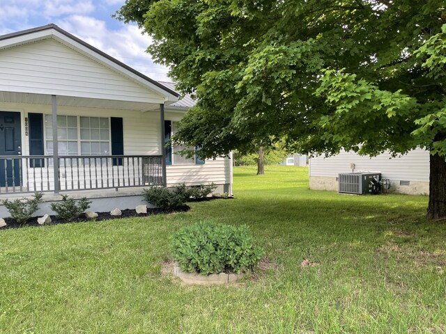 1004 E Railroad St, Waverly, TN 37185 - view of grassy yard featuring central AC and covered porch