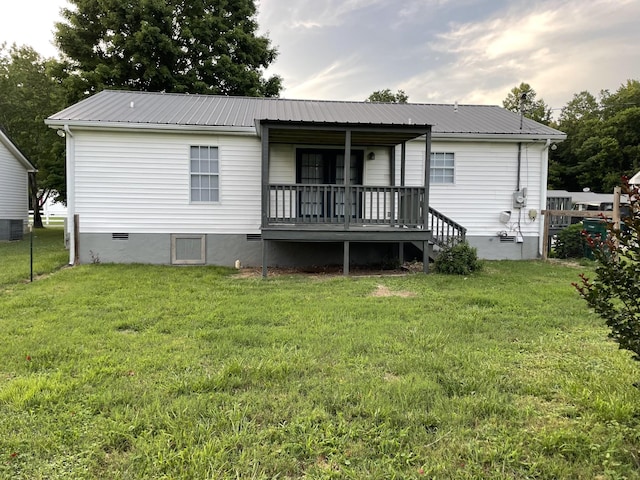 1004 E Railroad St, Waverly, TN 37185 - back of house with metal roof, a yard, and a porch
