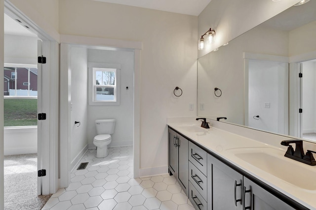 1038 Camden Trl, Greenbrier, TN 37073 - bathroom featuring double vanity, tile patterned flooring, baseboards, and toilet