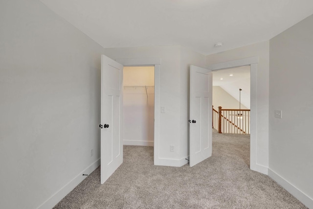 1038 Camden Trl, Greenbrier, TN 37073 - unfurnished bedroom featuring carpet flooring, a spacious closet, baseboards, and a closet